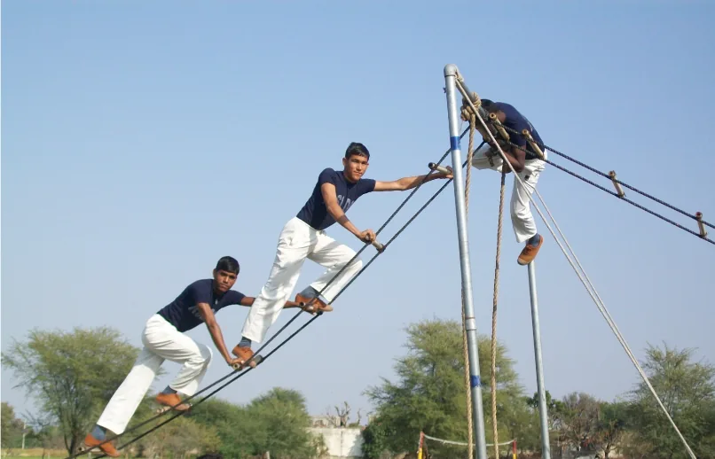 Security trainees completing an outdoor obstacle course